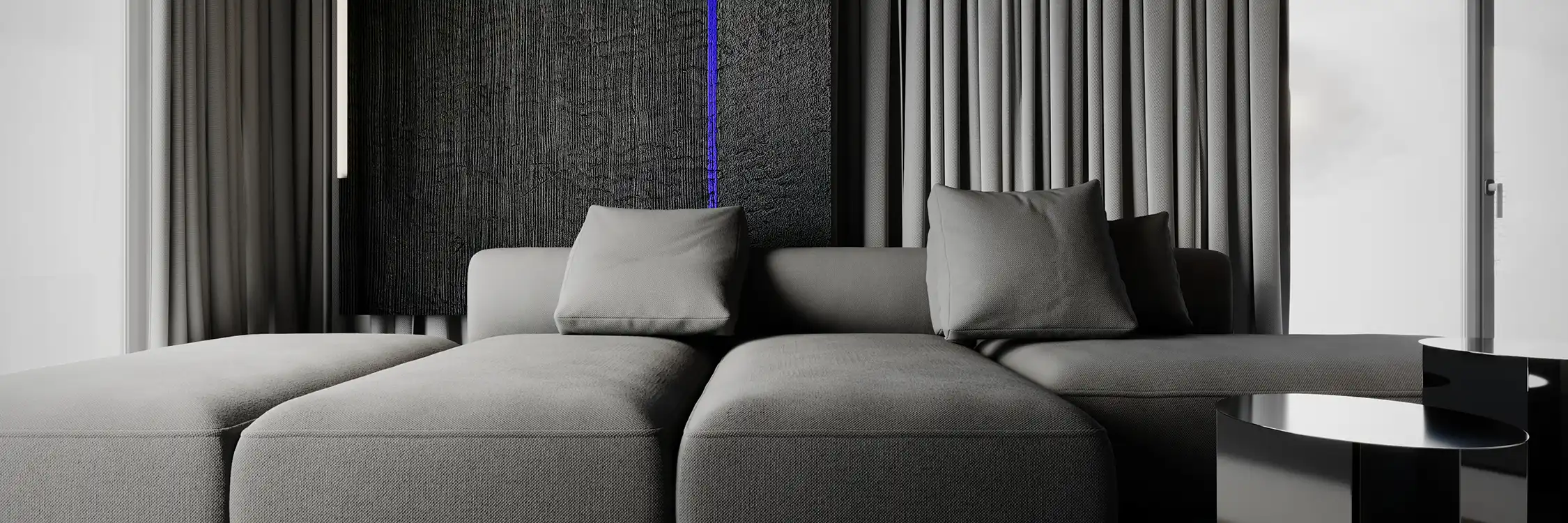 Elegancka szara sofa modułowa w nowoczesnym salonie z dekoracyjnym panelem ściennym i niebieskim oświetleniem LED.
